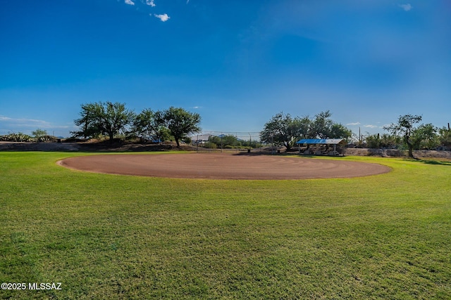 view of community with a lawn and curved driveway