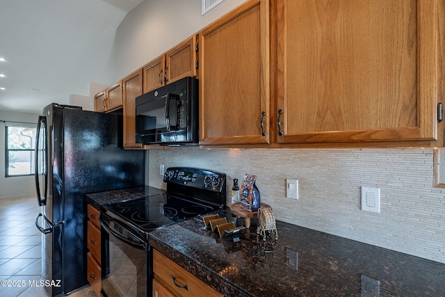 kitchen with visible vents, backsplash, tile patterned floors, black appliances, and brown cabinetry