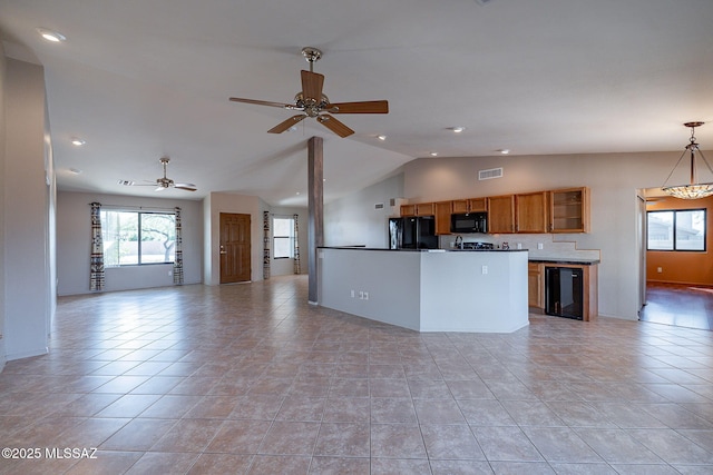 kitchen featuring open floor plan, visible vents, a ceiling fan, black appliances, and brown cabinetry
