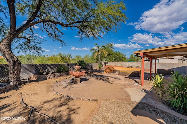 view of yard featuring a ceiling fan, a fenced backyard, and a patio area