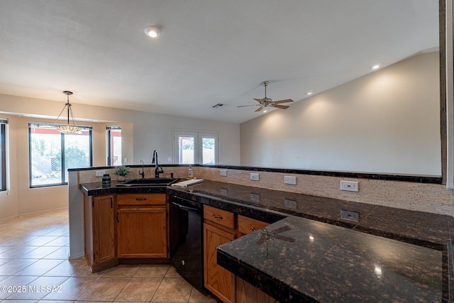 kitchen with tile counters, decorative light fixtures, a sink, black dishwasher, and brown cabinetry