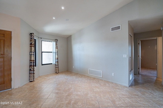 empty room featuring recessed lighting, baseboards, vaulted ceiling, and visible vents
