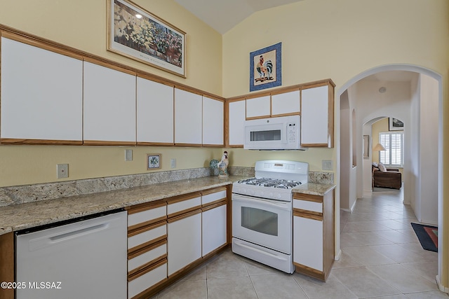 64235 E Greenbelt Ln, Saddlebrooke, AZ 85739 - kitchen featuring white cabinetry, light tile patterned floors, light countertops, and white appliances