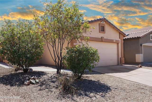 7536 E Fair Meadows Loop, Tucson, AZ 85756 - view of front of house featuring stucco siding, a tile roof, concrete driveway, and a garage