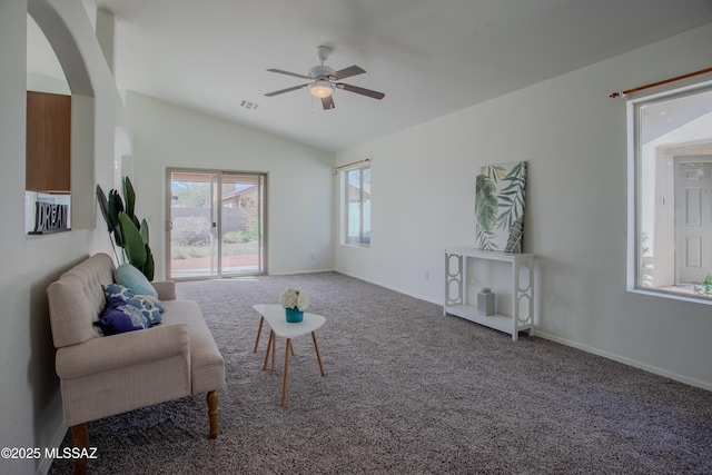 sitting room with vaulted ceiling, carpet floors, arched walkways, visible vents, and ceiling fan
