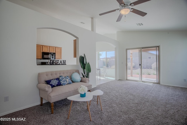 unfurnished room with carpet flooring, high vaulted ceiling, arched walkways, ceiling fan, and visible vents