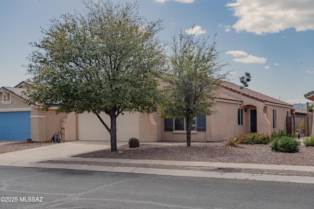 view of front of house featuring stucco siding, an attached garage, and concrete driveway