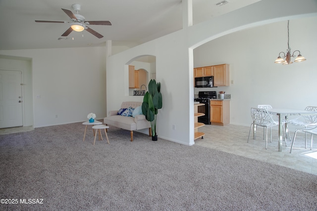 living area featuring light carpet, baseboards, ceiling fan with notable chandelier, visible vents, and arched walkways