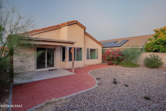 back of property with a patio area, fence, stucco siding, and a tiled roof