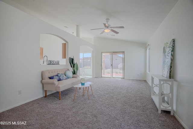 living area featuring baseboards, ceiling fan, and carpet