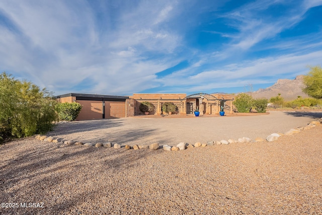 view of front of home featuring a garage and a mountain view