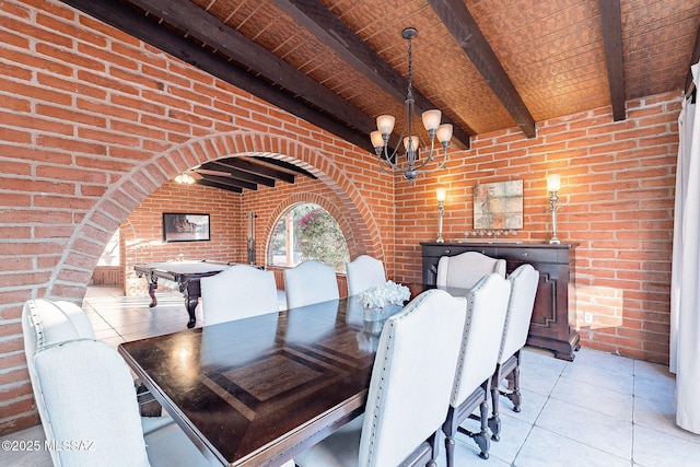 unfurnished dining area with light tile patterned flooring, brick wall, beamed ceiling, and a notable chandelier