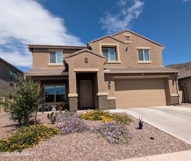 traditional-style home featuring concrete driveway, stucco siding, an attached garage, and a tile roof