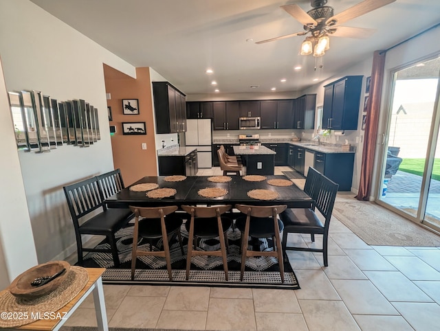 dining space with recessed lighting, light tile patterned floors, and a ceiling fan
