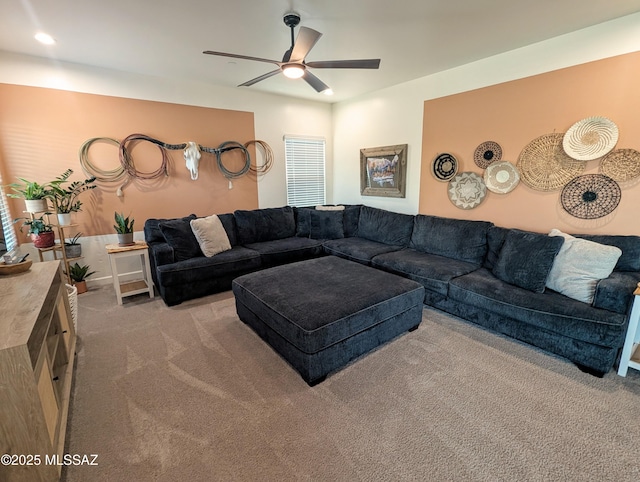 living area featuring a ceiling fan and carpet flooring