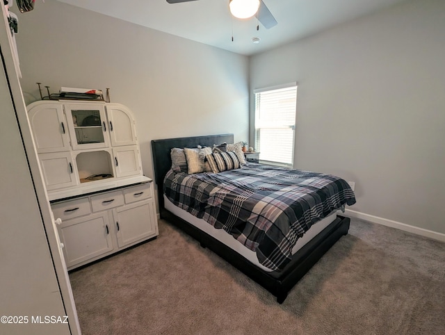 bedroom featuring baseboards, a ceiling fan, and carpet