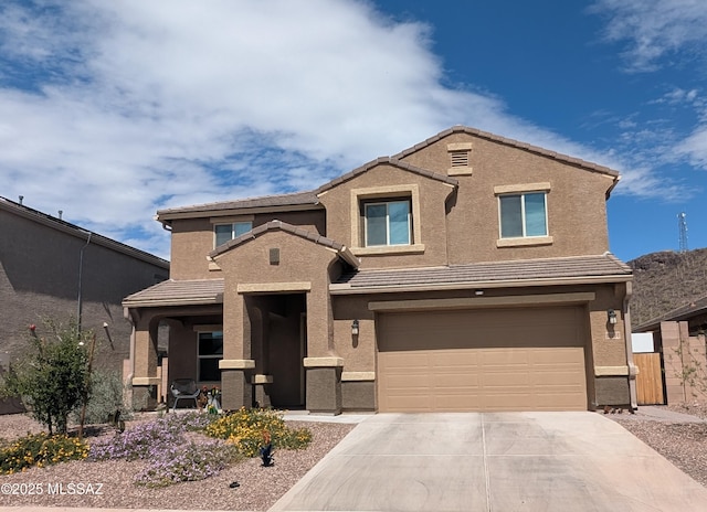 traditional-style house with concrete driveway, stucco siding, a garage, and a tile roof