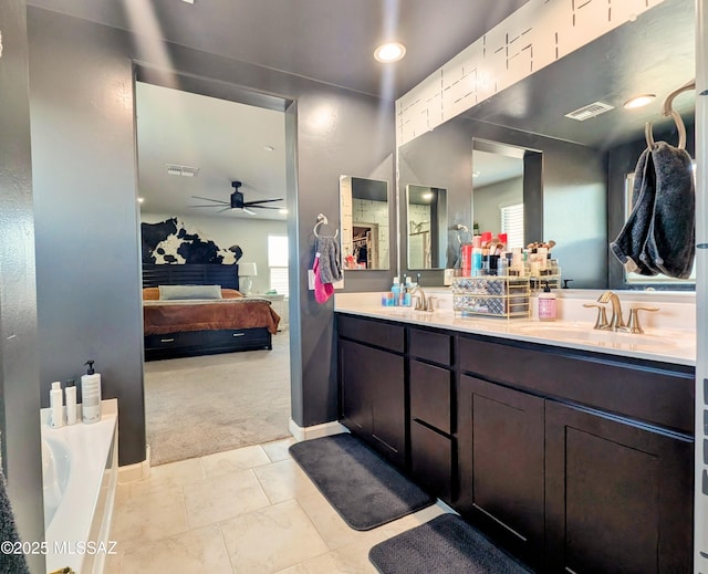 full bathroom with ensuite bathroom, visible vents, a sink, and a ceiling fan