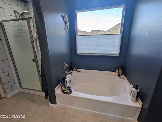 full bath featuring a shower stall and a garden tub