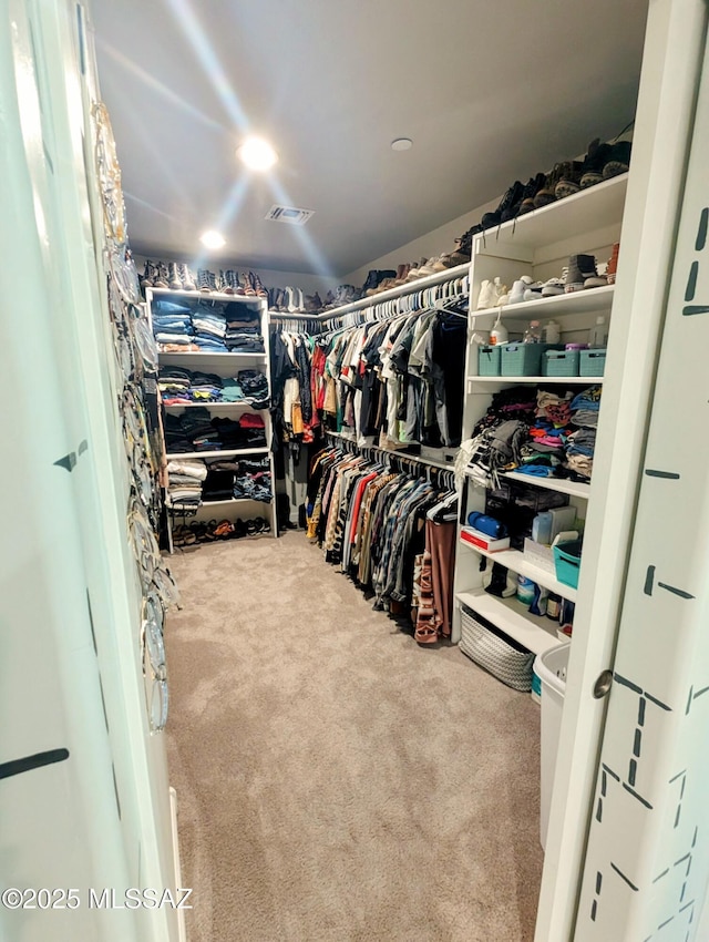 spacious closet with visible vents and carpet floors