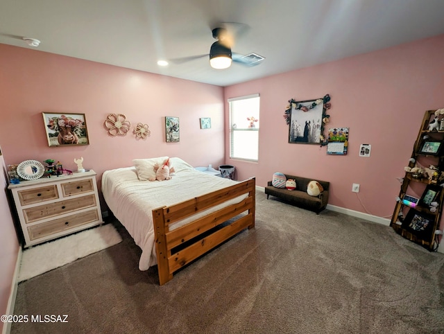 carpeted bedroom with visible vents, baseboards, and a ceiling fan