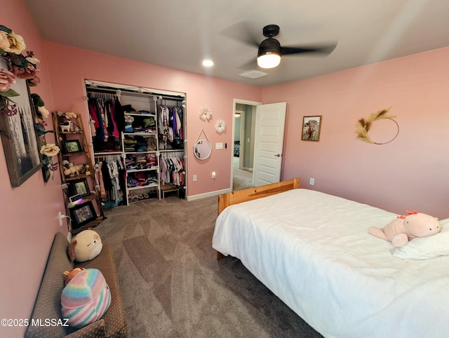 bedroom with a closet, baseboards, carpet flooring, visible vents, and ceiling fan