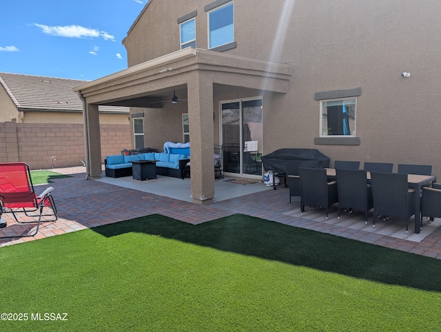 exterior space with outdoor lounge area, ceiling fan, and fence