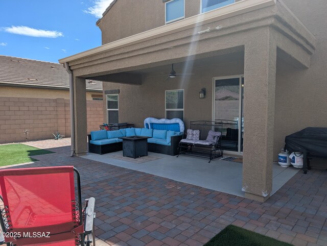 view of patio / terrace with fence, a ceiling fan, and an outdoor hangout area
