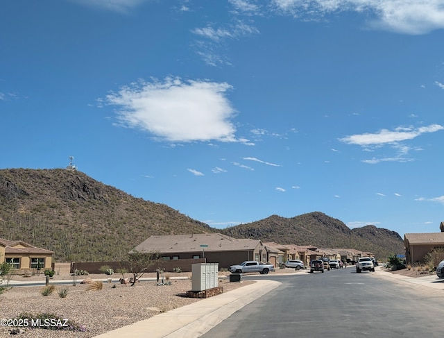 view of street with curbs and a mountain view