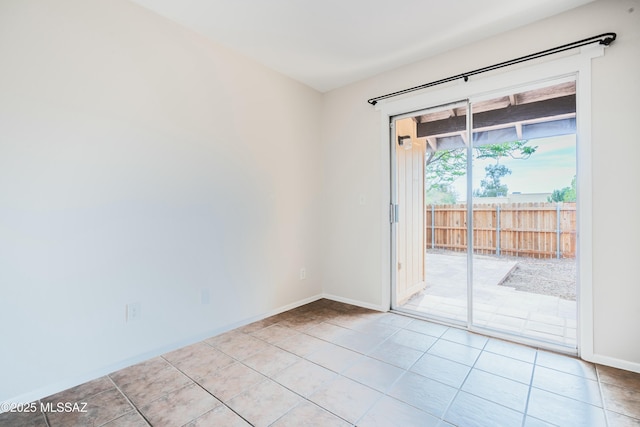 unfurnished room with baseboards and light tile patterned floors