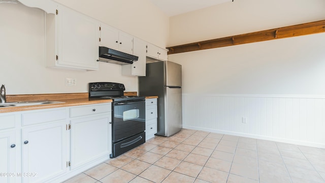 kitchen featuring white cabinets, black range with electric cooktop, under cabinet range hood, a sink, and freestanding refrigerator