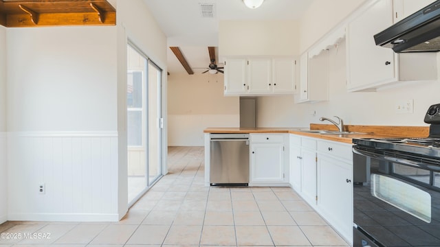 kitchen featuring a wainscoted wall, a sink, dishwasher, under cabinet range hood, and black electric range