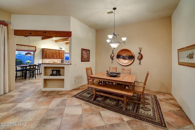 dining area featuring visible vents and a notable chandelier