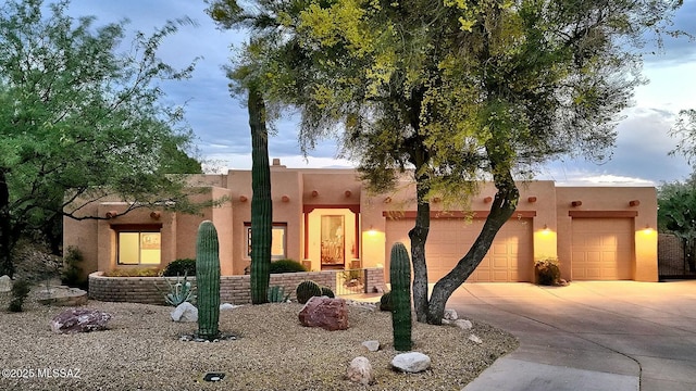 southwest-style home with an attached garage and driveway