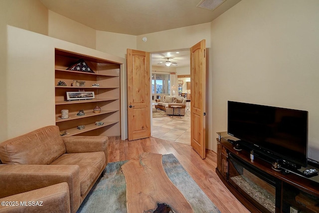 living room featuring light wood-style floors and visible vents