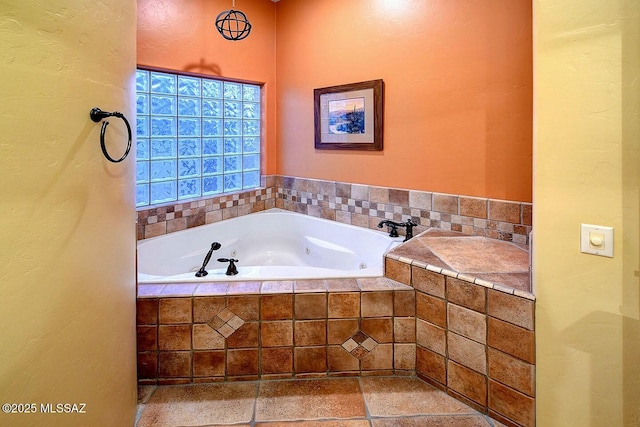 bathroom with a tub with jets