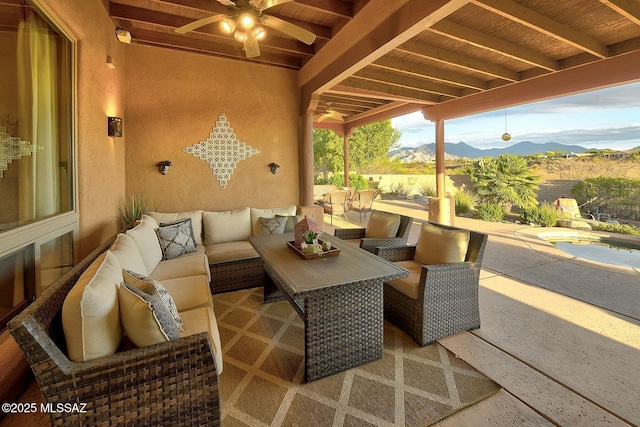 view of patio / terrace featuring outdoor lounge area, ceiling fan, and a mountain view