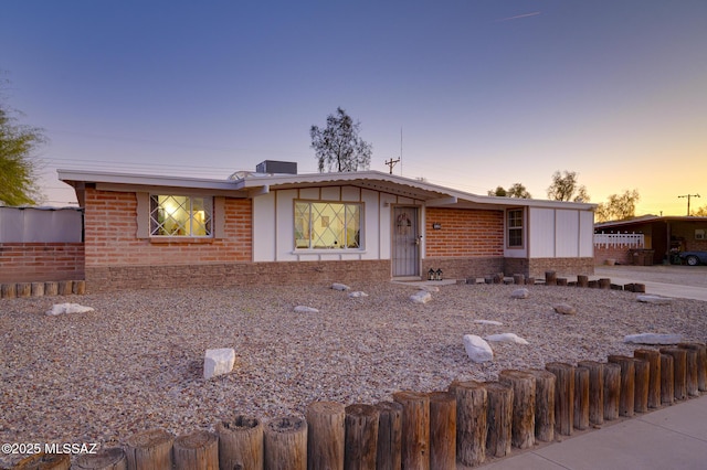 view of front of home featuring fence