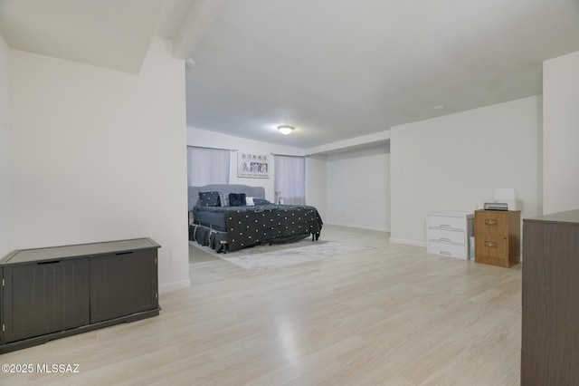 bedroom featuring baseboards and wood finished floors