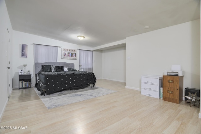 bedroom featuring baseboards and wood finished floors