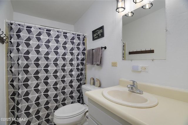 bathroom with toilet, vanity, and a shower with curtain