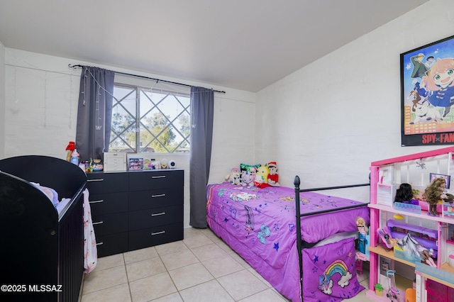 bedroom with light tile patterned floors