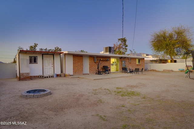 back of property with central air condition unit, fence, and a patio