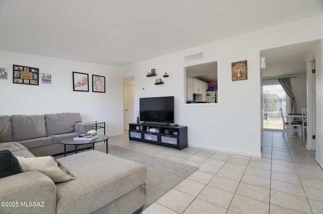 living room with light tile patterned flooring, baseboards, and visible vents
