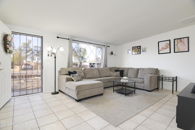 living area featuring visible vents and light tile patterned floors
