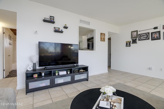 living area with tile patterned floors and visible vents