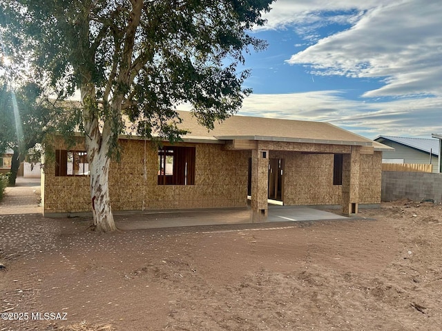 rear view of property with fence and a patio