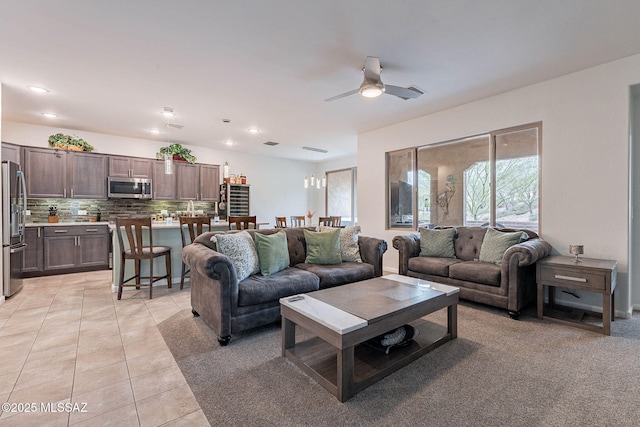 living area with a ceiling fan, recessed lighting, and light tile patterned floors