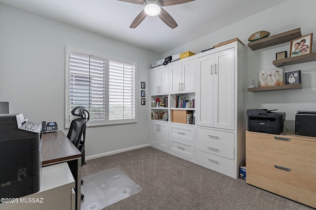 home office featuring baseboards, a ceiling fan, and carpet