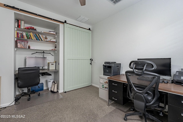 office area featuring baseboards and a barn door